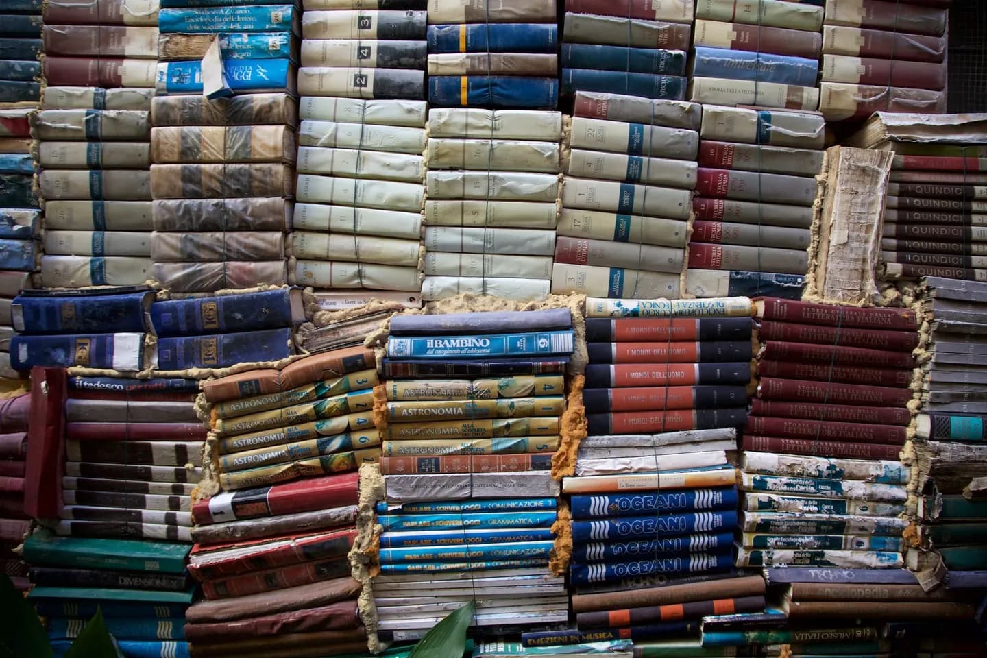 clipboard privacy: colourful vintage books stacked outdoors