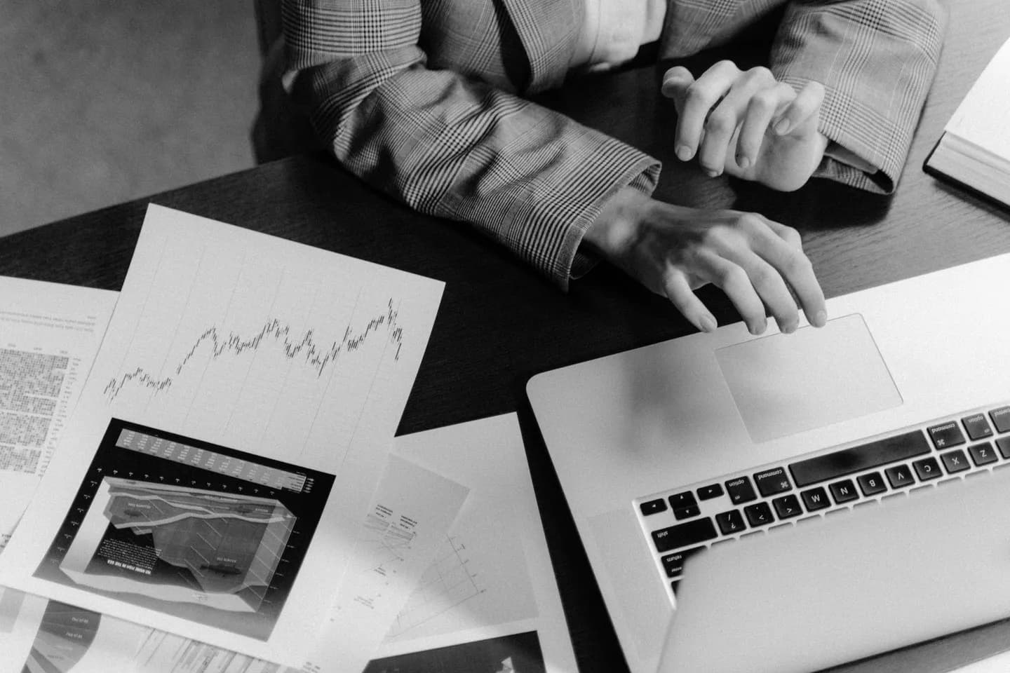 pdf table to markdown: a monochrome laptop workspace with business charts