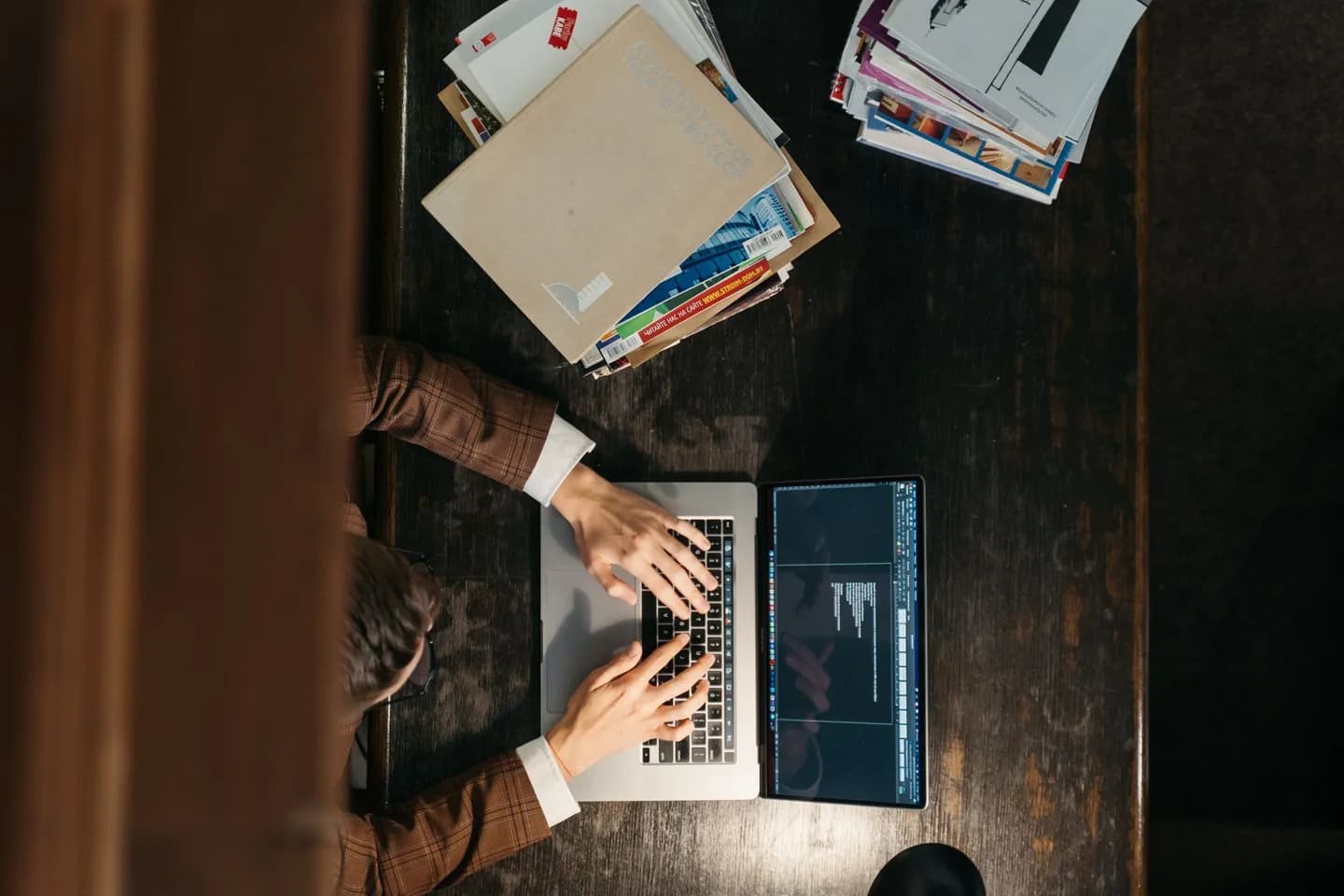 screenshot to markdown: hands typing on a laptop viewed from above